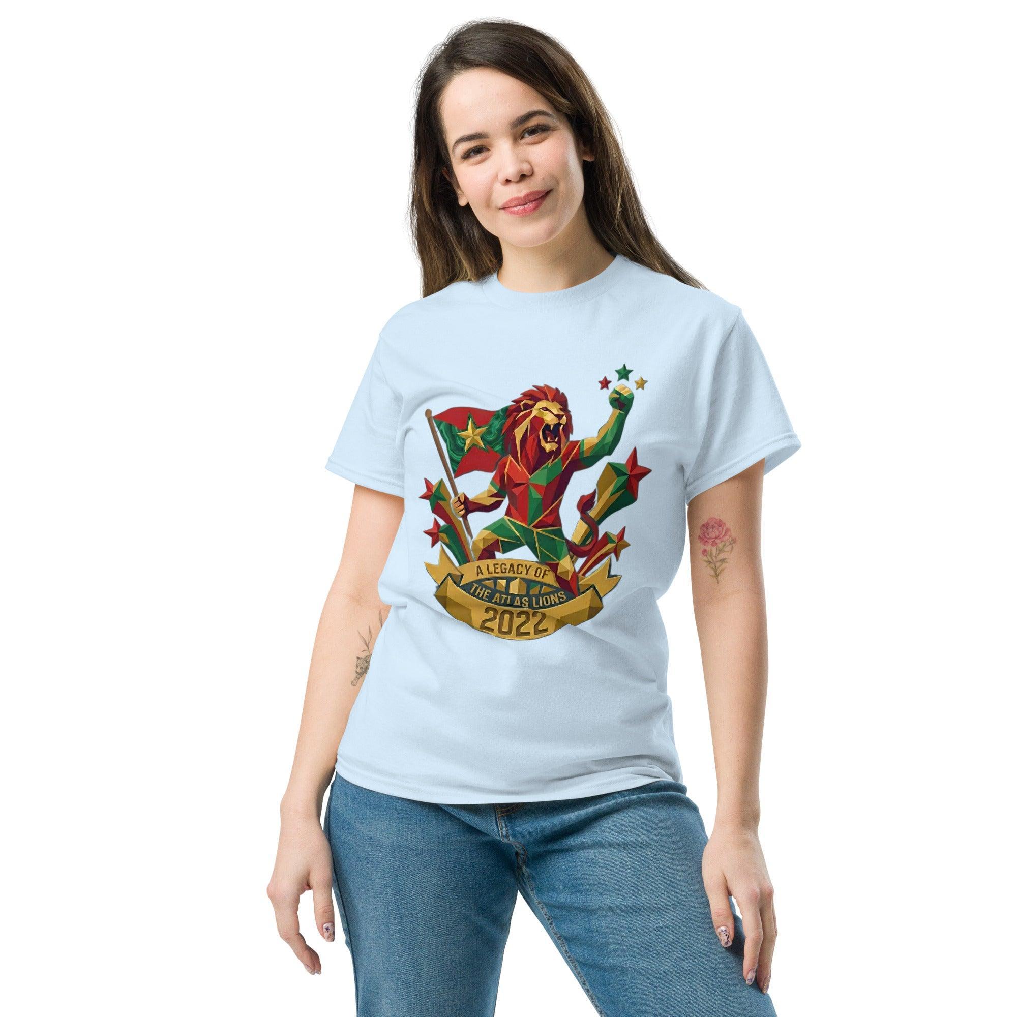 Woman wearing light blue t-shirt with geometric lion design, 'A Legacy of the Atlas Lions 2022' text, stars, and flag, perfect for football fans.