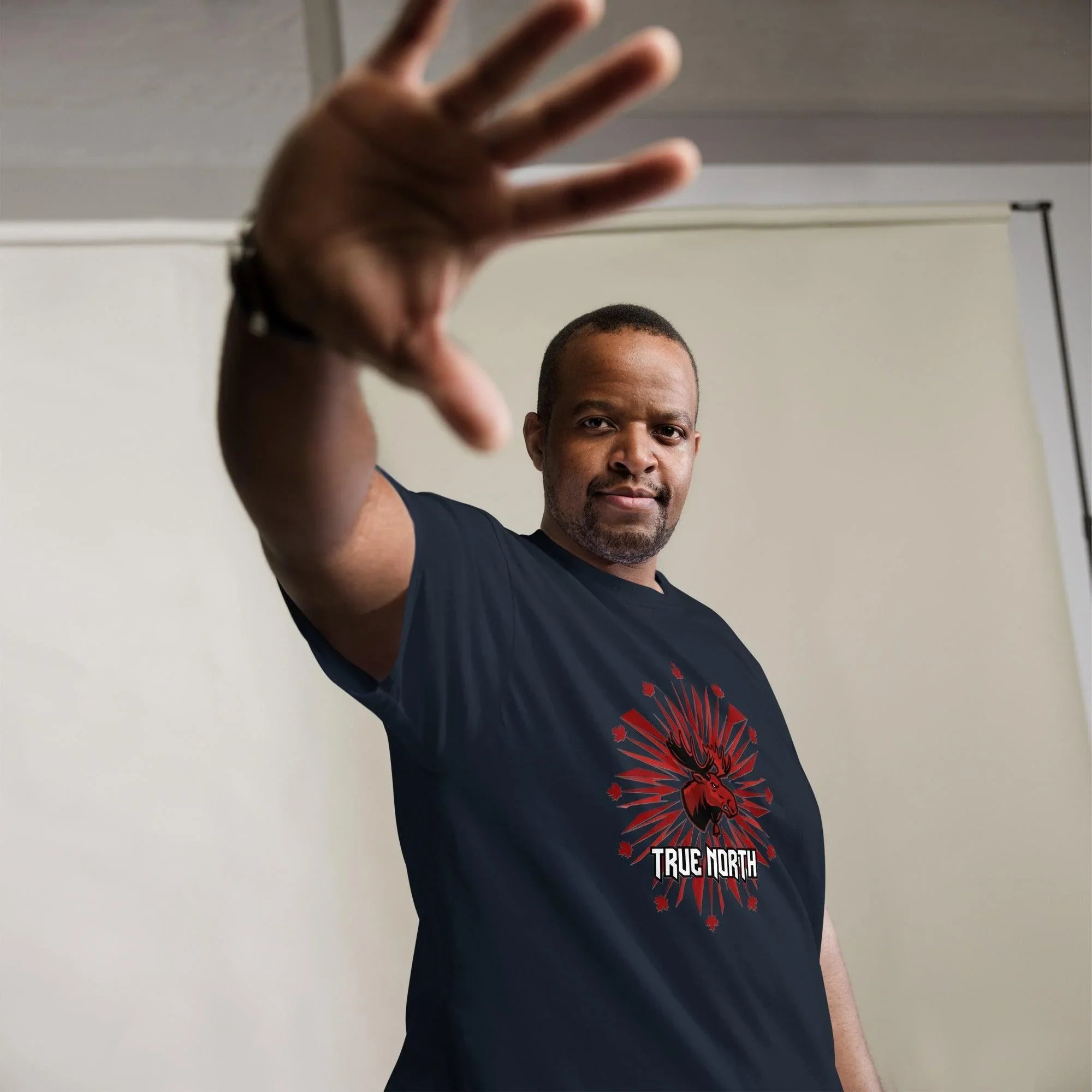 Man wearing True North moose graphic tee, custom fan apparel with bold red design